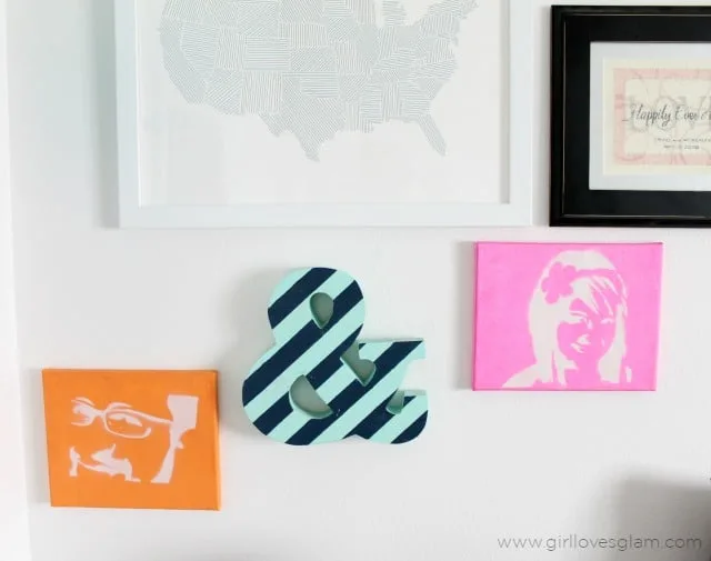 Stenciled portraits and striped ampersand corner gallery wall on www.girllovesglam.com